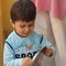 Sweet boy playing bells with spoon to in the Balcony during corona virus lockdown to give respect to doctors in IndiaÂ 